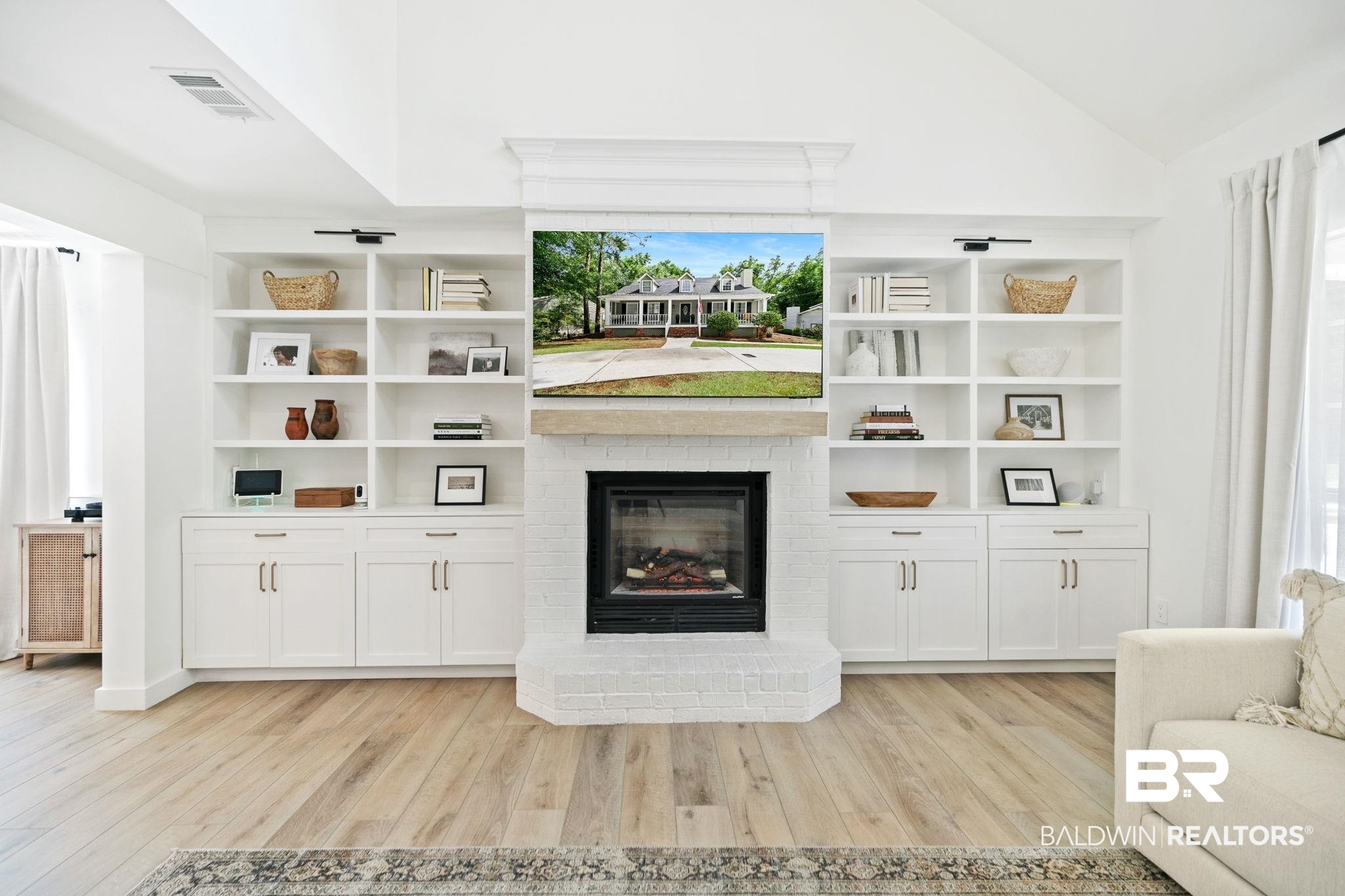 342 Ridgewood Drive Daphne, AL 36526 - Photo 33 of 36 Living room featuring light wood-type flooring, vaulted ceiling, a brick fireplace, and built in shelves