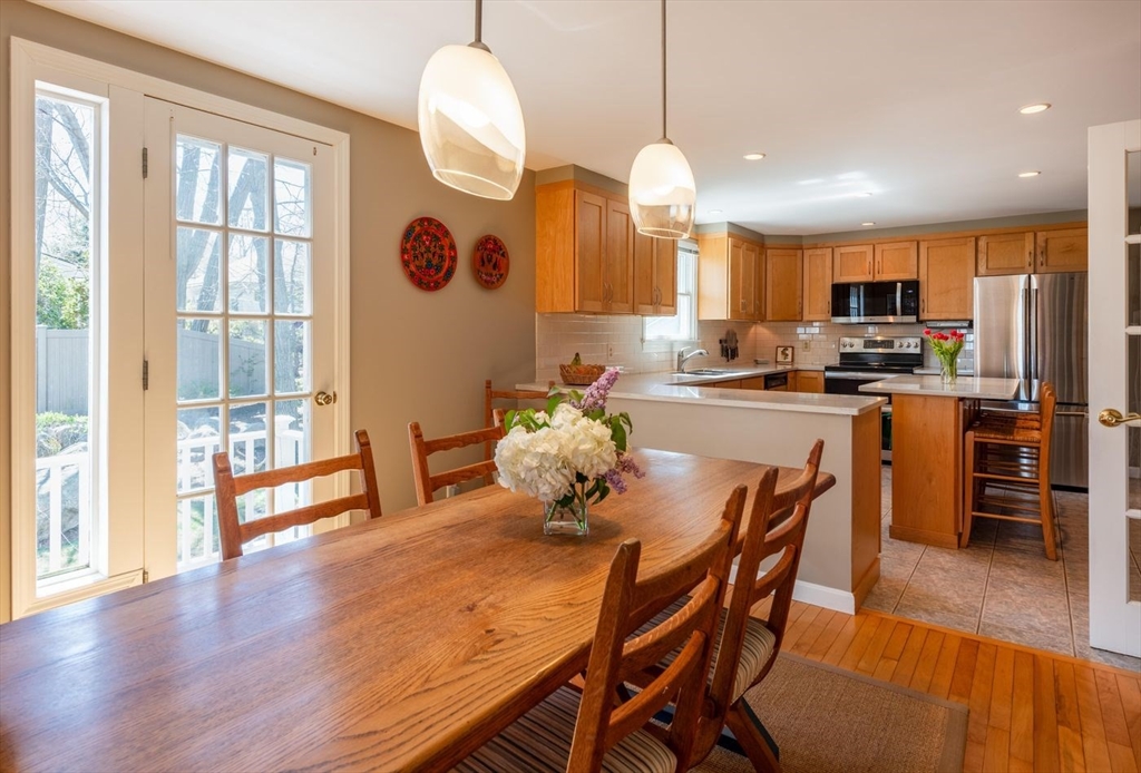 4 Graystone Road Gloucester, MA 01930 - Photo 14 of 34 a dining room with stainless steel appliances furniture a window and wooden floor