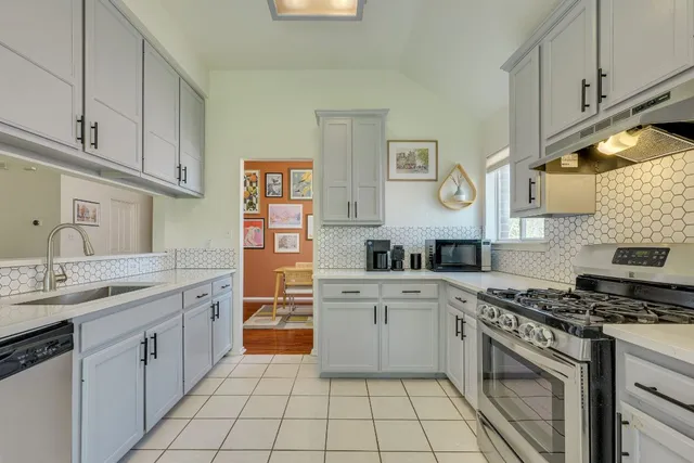 a kitchen with cabinets stainless steel appliances and a sink