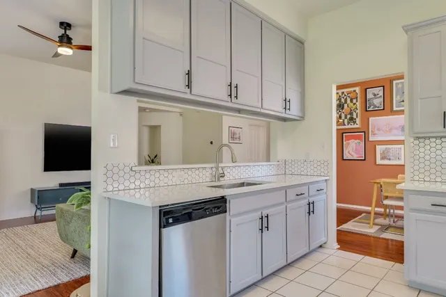 a kitchen with stainless steel appliances granite countertop a sink and a stove
