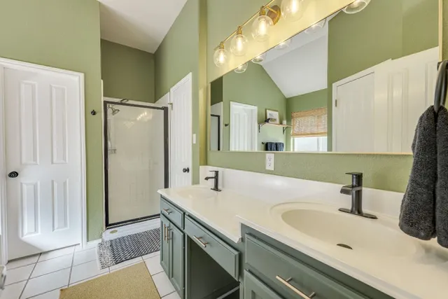 a spacious bedroom with a bed and a flat screen tv