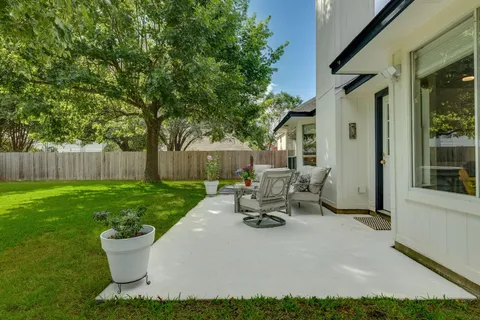 a view of backyard with seating area and green space