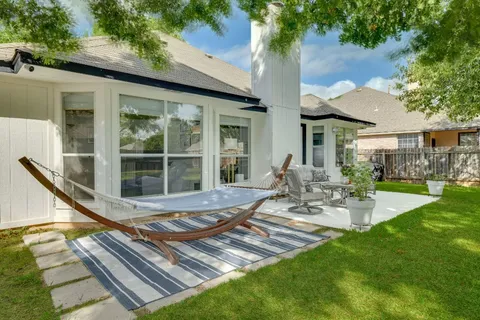 a view of a patio with table and chairs and potted plants