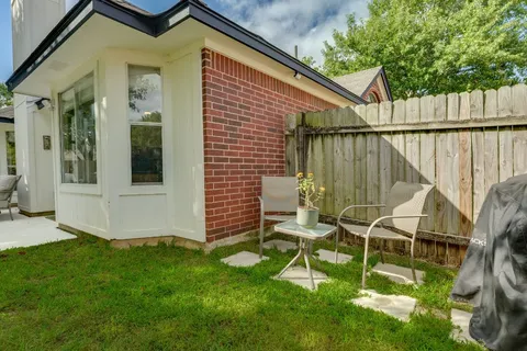 a view of backyard with seating and green space