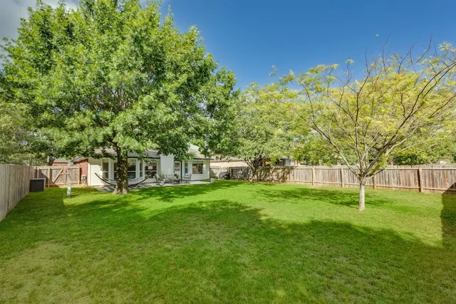 a view of a big yard next to a house