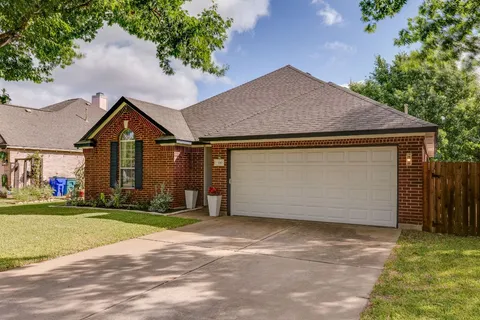 a backyard of a house with lots of green space and garden