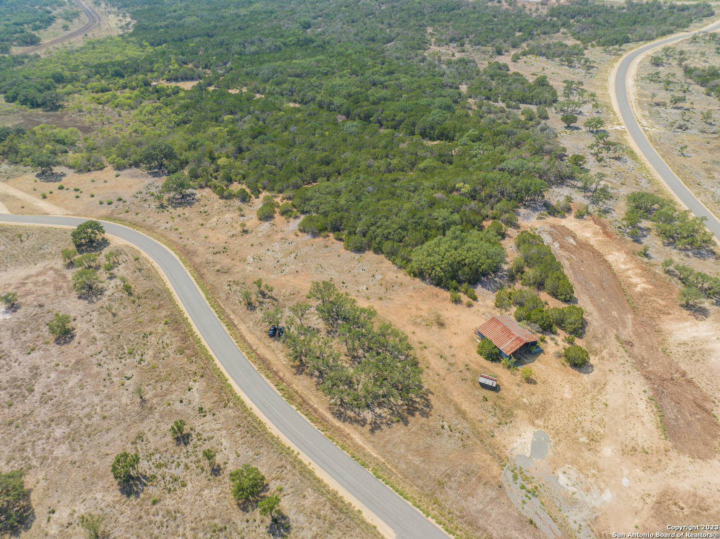 Lot 186 Grand Ranch Hondo, TX 78861 - Photo 7 of 9 a view of a dry yard with wooden fence