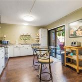 a view of a kitchen with furniture and wooden floor