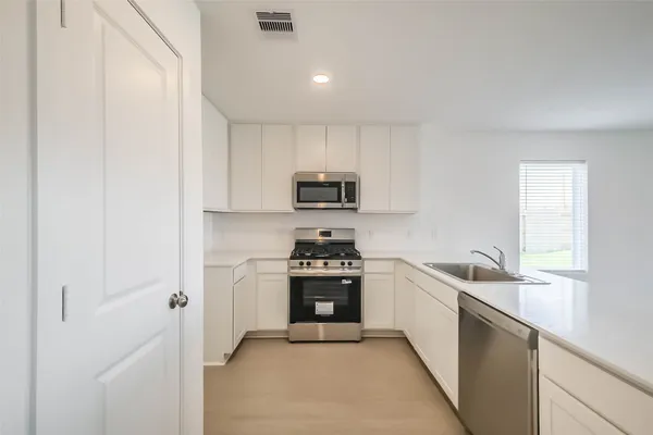 a kitchen with a stove and a sink