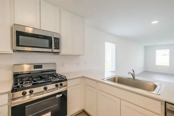 a kitchen with a stove and a microwave