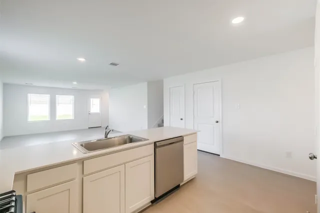 a kitchen with sink and window