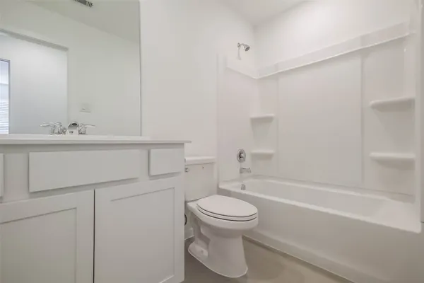a bathroom with a toilet and a bathtub