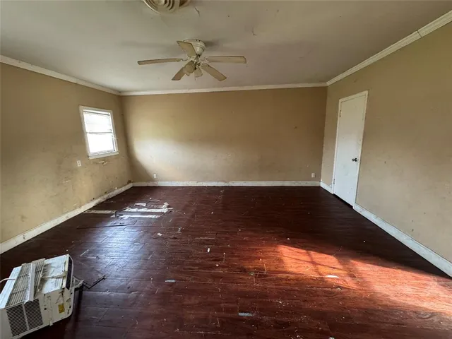 wooden floor in an empty room with a window