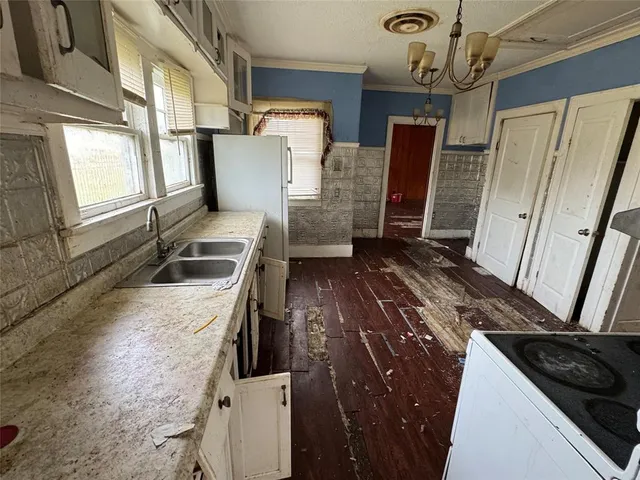 a kitchen with a sink stove and refrigerator