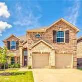 a front view of a house with a yard and a garage