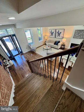 a kitchen with stainless steel appliances kitchen island granite countertop a stove a sink a dining table and chairs