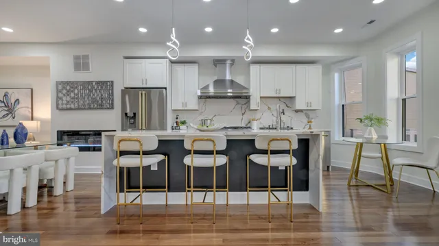 a kitchen with stainless steel appliances granite countertop a refrigerator and a stove top oven