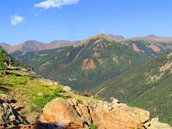 a view of a mountain with a lake in the background