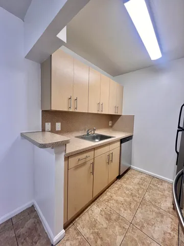 a kitchen with a stove a sink and a refrigerator