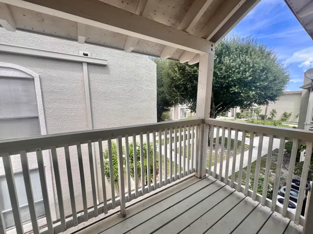 a view of a balcony with wooden floor