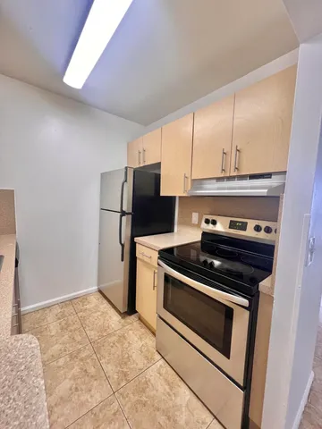 a kitchen with a stove and a refrigerator