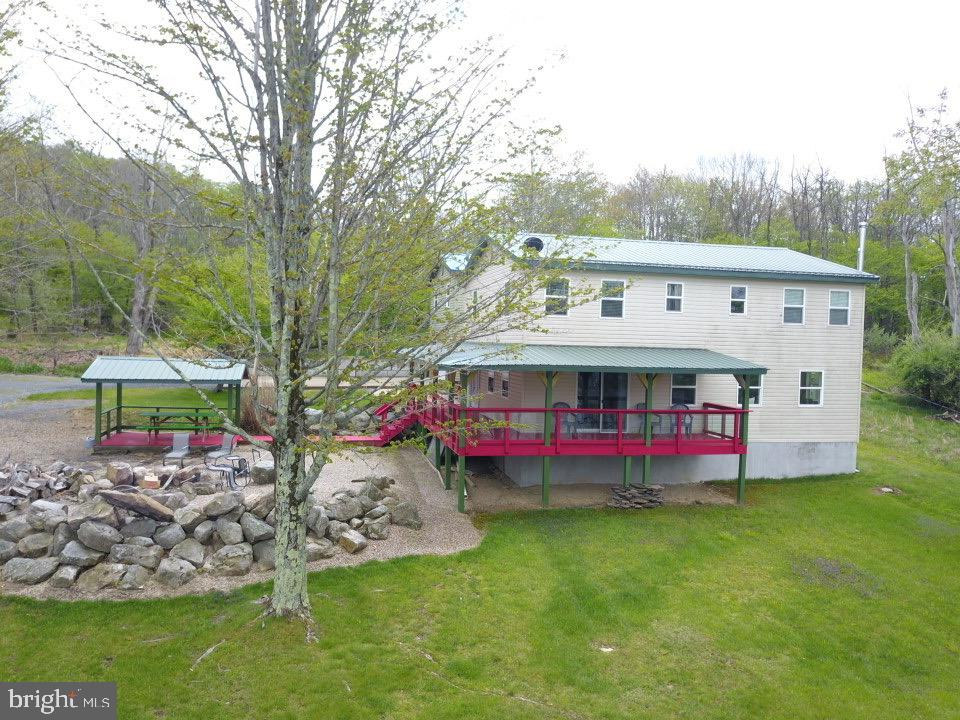 106 North Rock Ridge Lane Mount Storm, WV 26739 - Photo 31 of 78 a view of a house with a yard deck and sitting area
