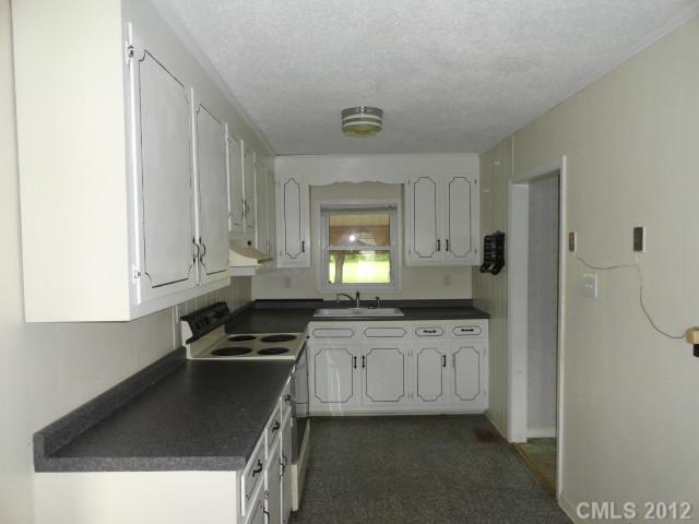 1420 Barger Road Salisbury, NC 28146 - Photo 7 of 7 a kitchen with granite countertop a sink a stove and cabinets