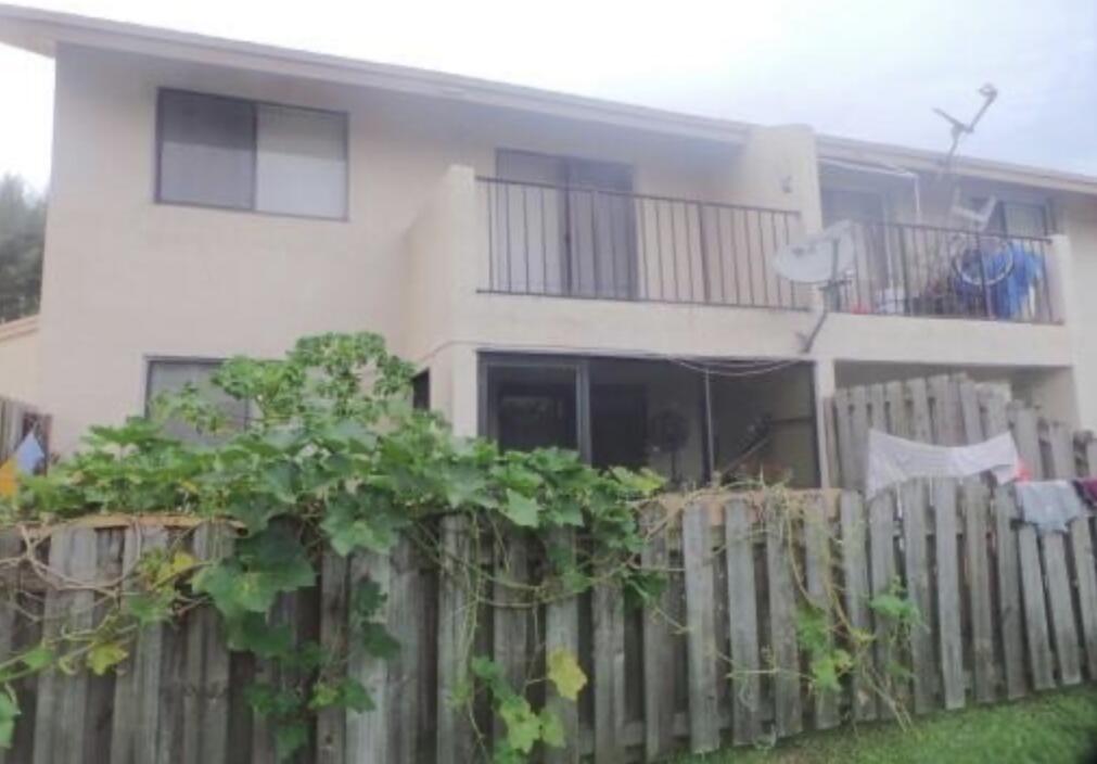 200 Nottingham Circle, Unit J Greenacres, FL 33463 - Photo 3 of 12 a front view of a house with a garden