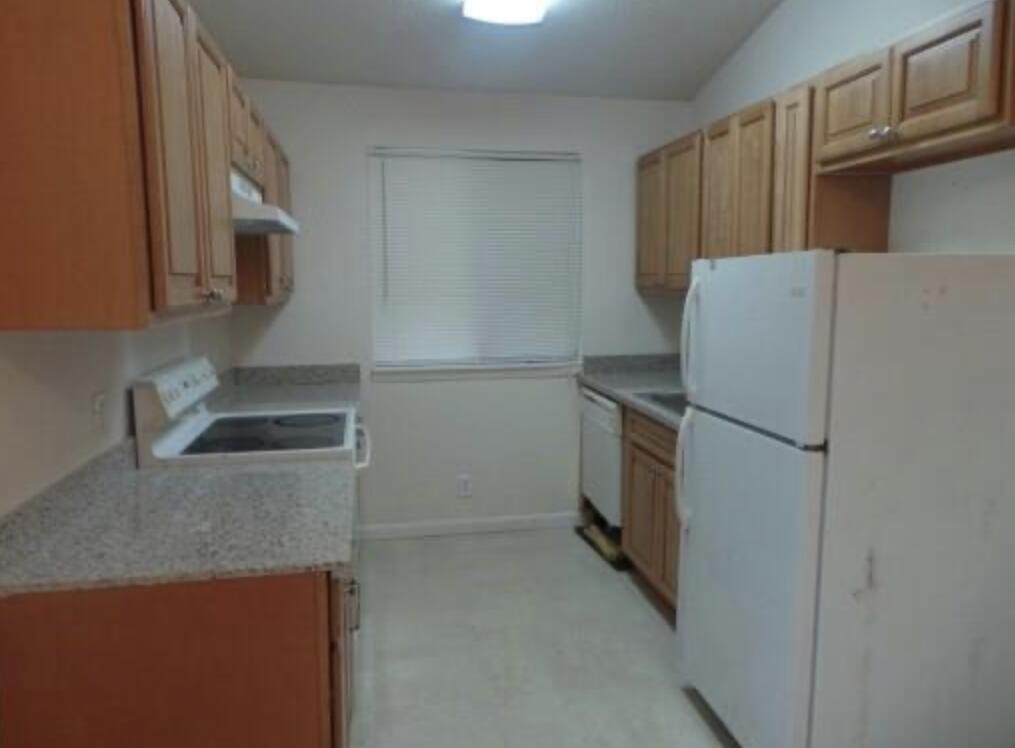 200 Nottingham Circle, Unit J Greenacres, FL 33463 - Photo 6 of 12 a kitchen with a refrigerator and a sink