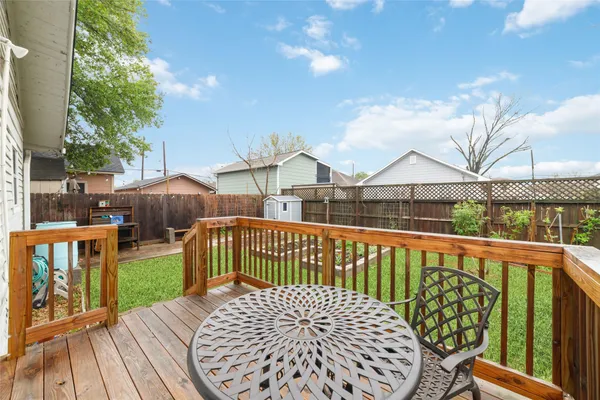 a view of a wooden chairs and table in the balcony