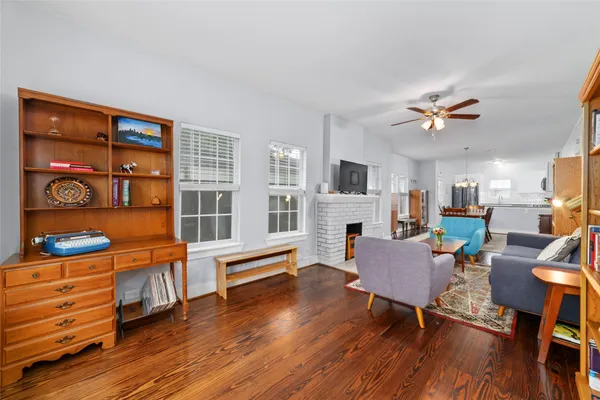 a living room with furniture wooden floor and window with wooden floor