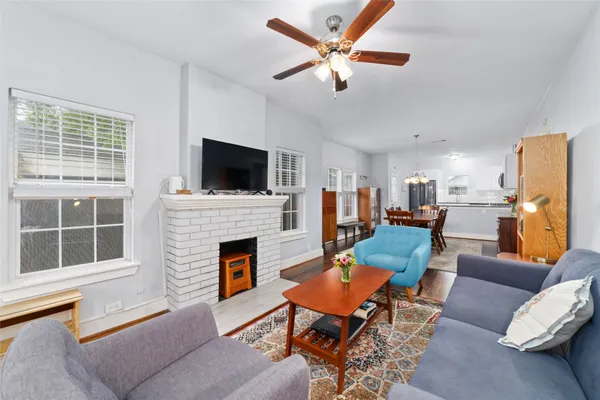 a living room with furniture a fireplace and a flat screen tv