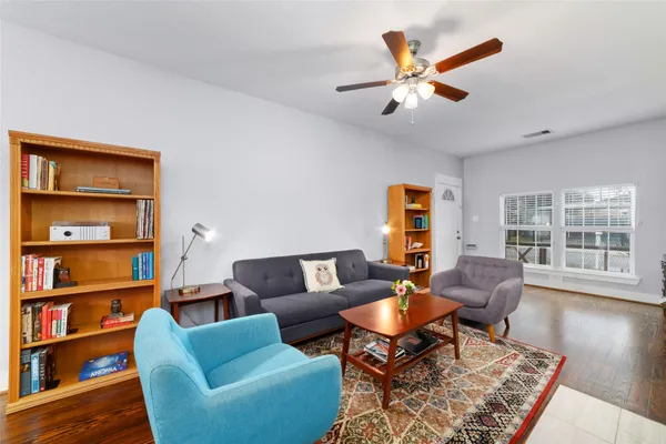 a living room with furniture and a book shelf