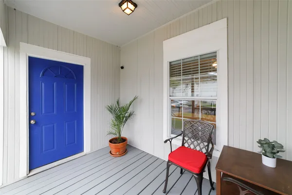 a living room with furniture and potted plant