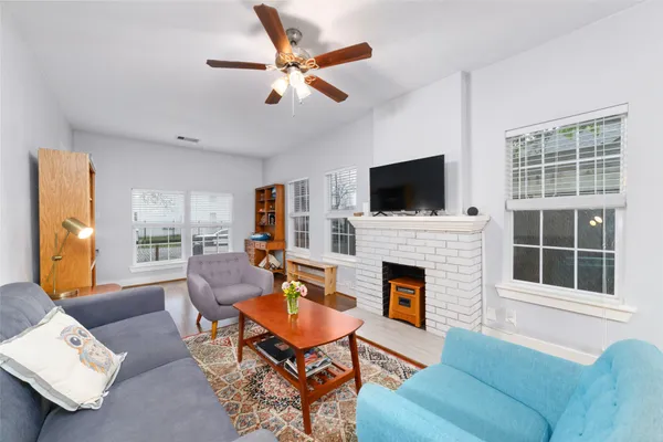 a living room with furniture fireplace and a flat screen tv