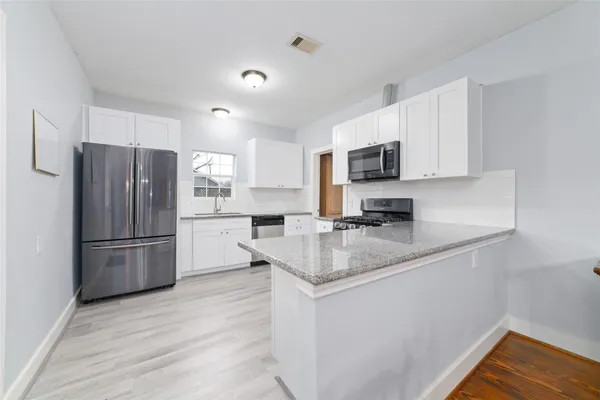 a kitchen with a refrigerator sink and microwave
