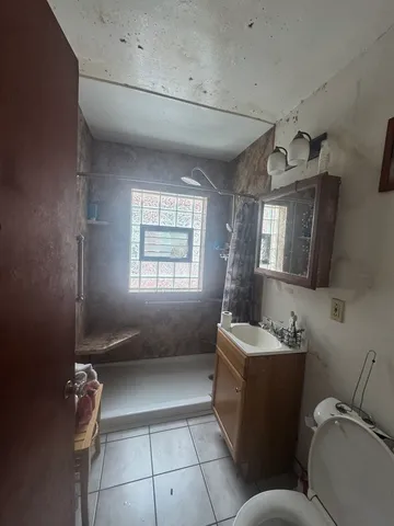 a bathroom with a sink a toilet and mirror