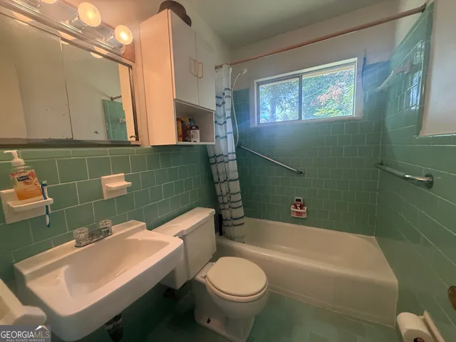 a bathroom with a sink a toilet and a bathtub