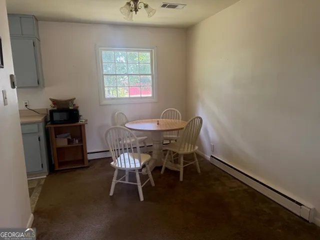 a dining room with furniture and window