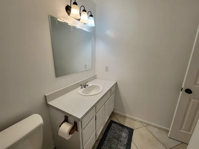 a bathroom with a sink toilet and mirror