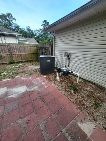 a backyard of a house with outdoor seating