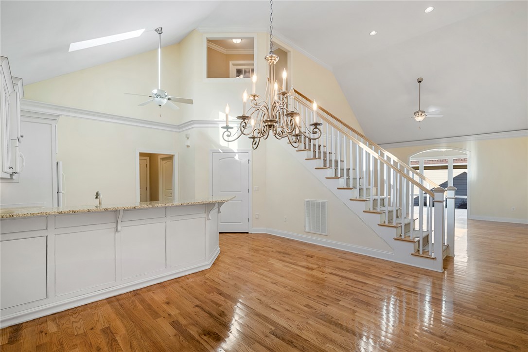 16 Oleander Drive Anderson, SC 29621 - Photo 10 of 37 Hardwood floors and soaring vaulted ceilings with an elegant chandelier define this bright living space.