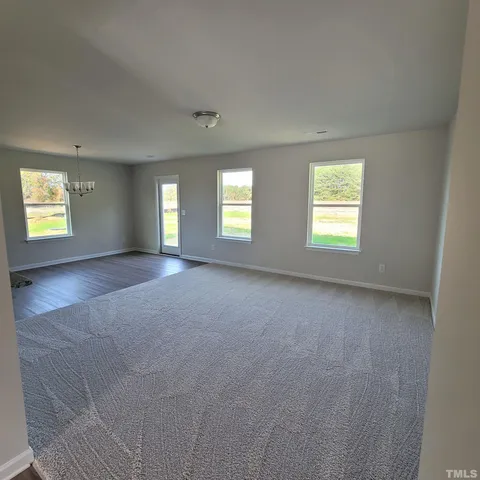 a view of an empty room with windows