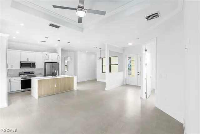 a view of a kitchen with a sink and stainless steel appliances