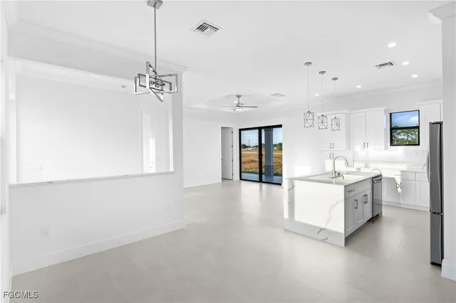 a large white kitchen with cabinets