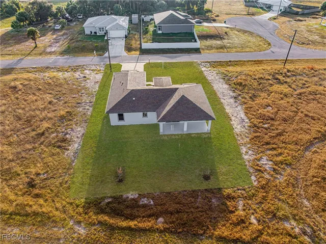 an aerial view of a house with a yard