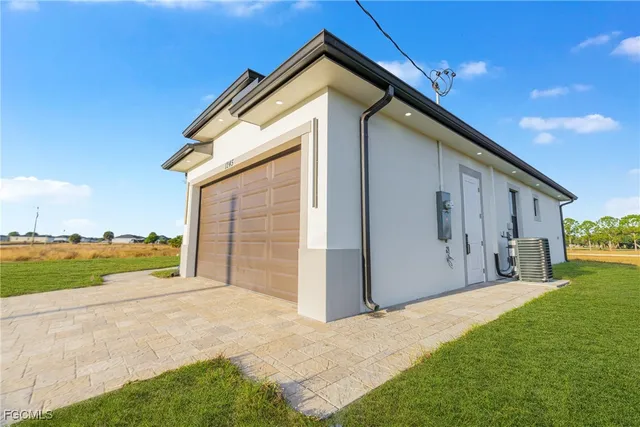a front view of house with yard and garage
