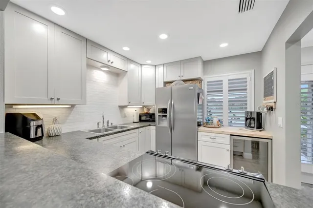 a view of a room with lots of furniture and white cabinets