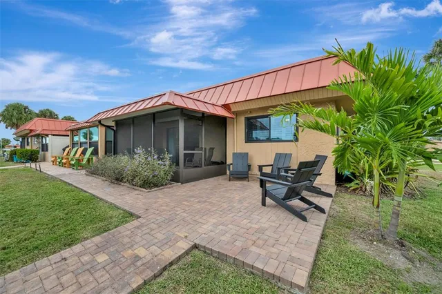 a bed sitting in a bedroom next to a window and a lamp