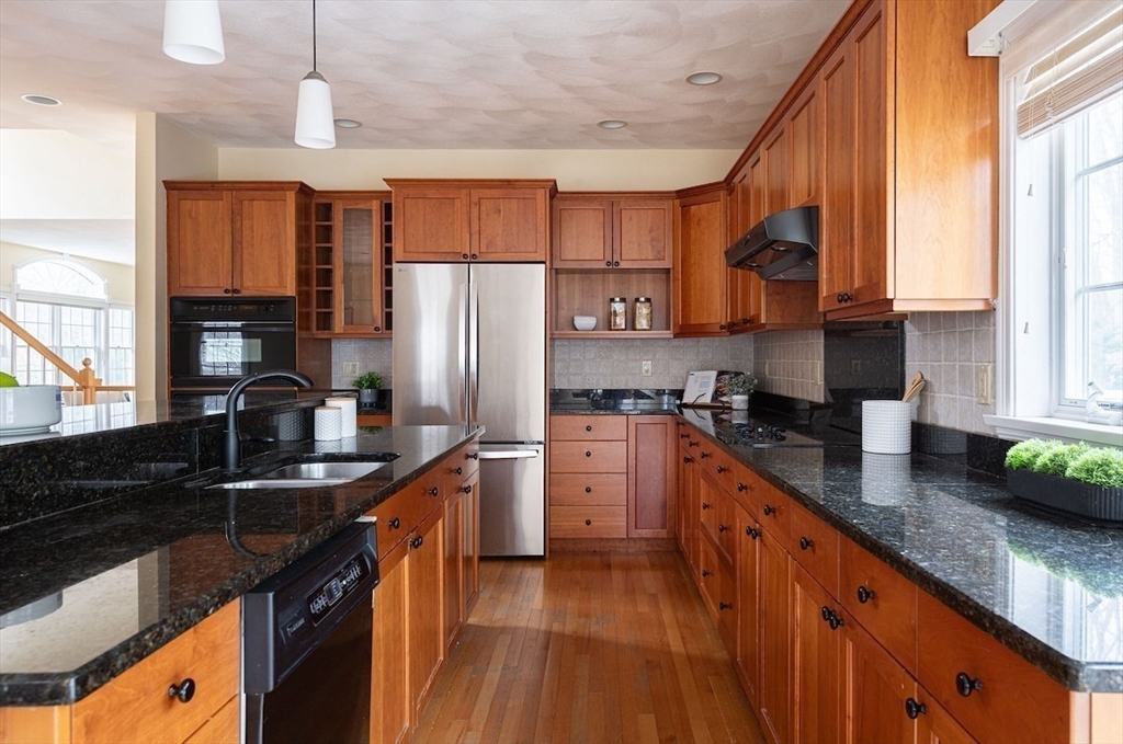 21 Bryant Road Lexington, MA 02420 - Photo 17 of 33 a kitchen with stainless steel appliances granite countertop a sink a stove and a refrigerator